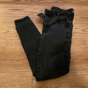 Likely worn skinny black jeans